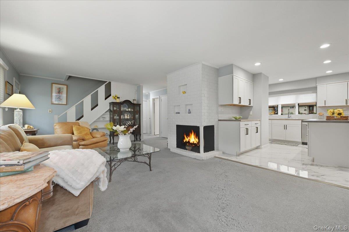 16 Ridge Drive East Roslyn, NY 11576 - Photo 16 of 40 a living room with furniture and a fireplace