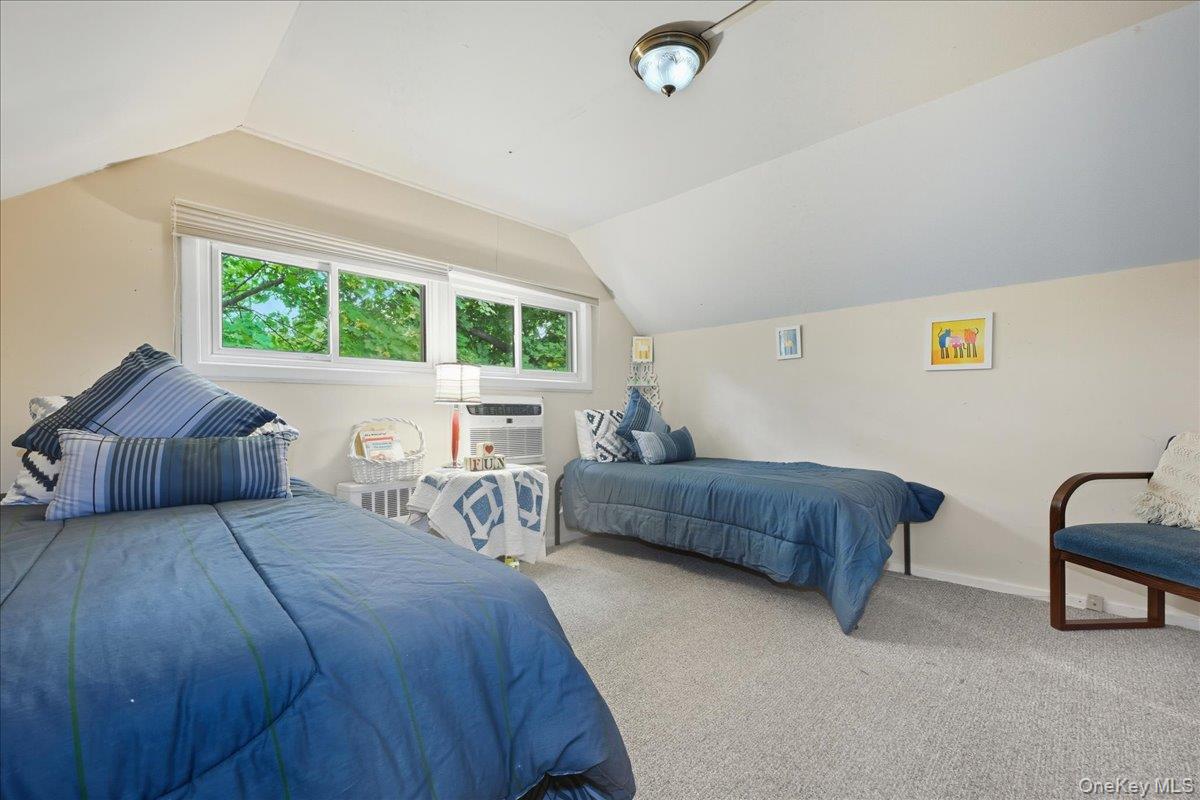 16 Ridge Drive East Roslyn, NY 11576 - Photo 28 of 40 a bedroom with a bed and a couch