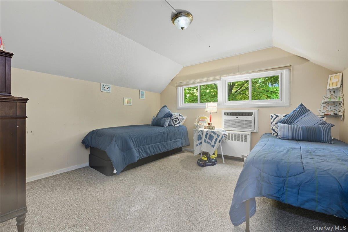 16 Ridge Drive East Roslyn, NY 11576 - Photo 29 of 40 a bedroom with a bed and a large window
