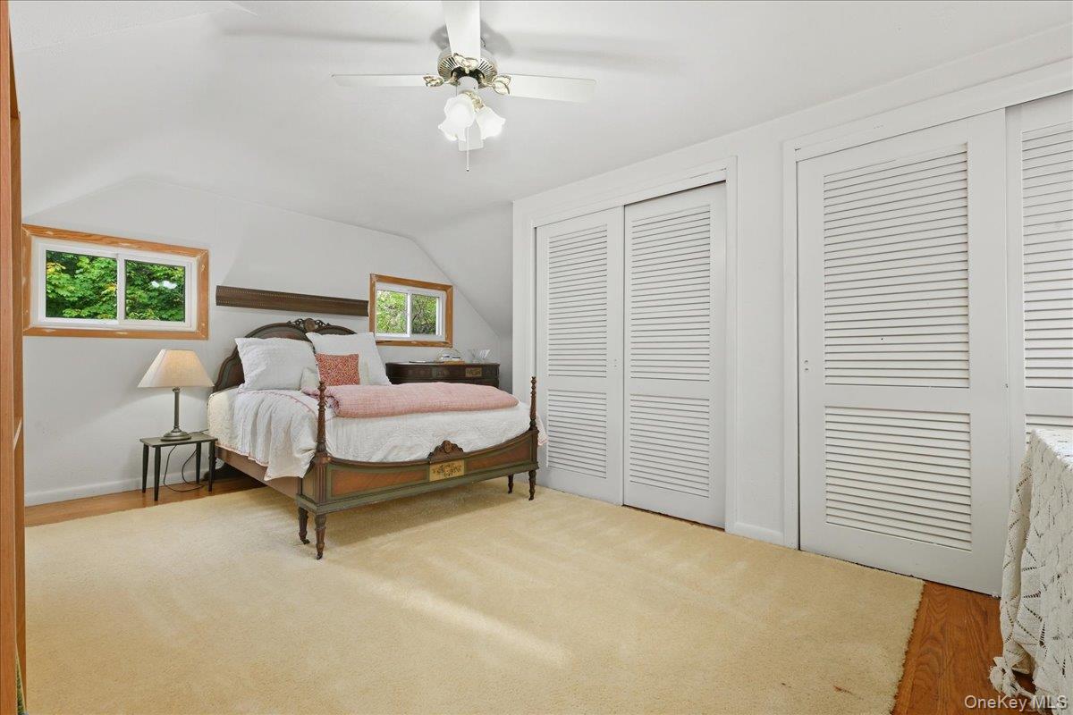 16 Ridge Drive East Roslyn, NY 11576 - Photo 33 of 40 a bedroom with a bed and a chandelier