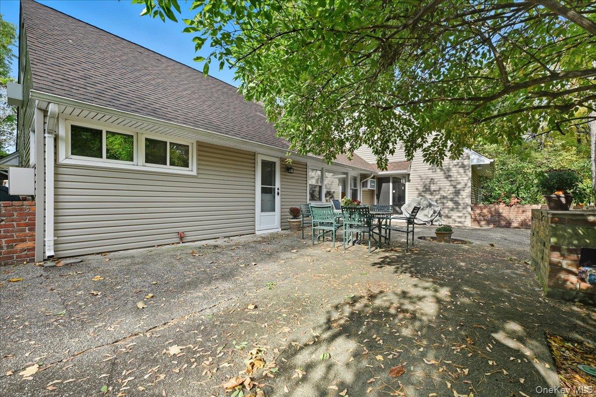16 Ridge Drive East Roslyn, NY 11576 - Photo 36 of 40 a view of a house with backyard and trees