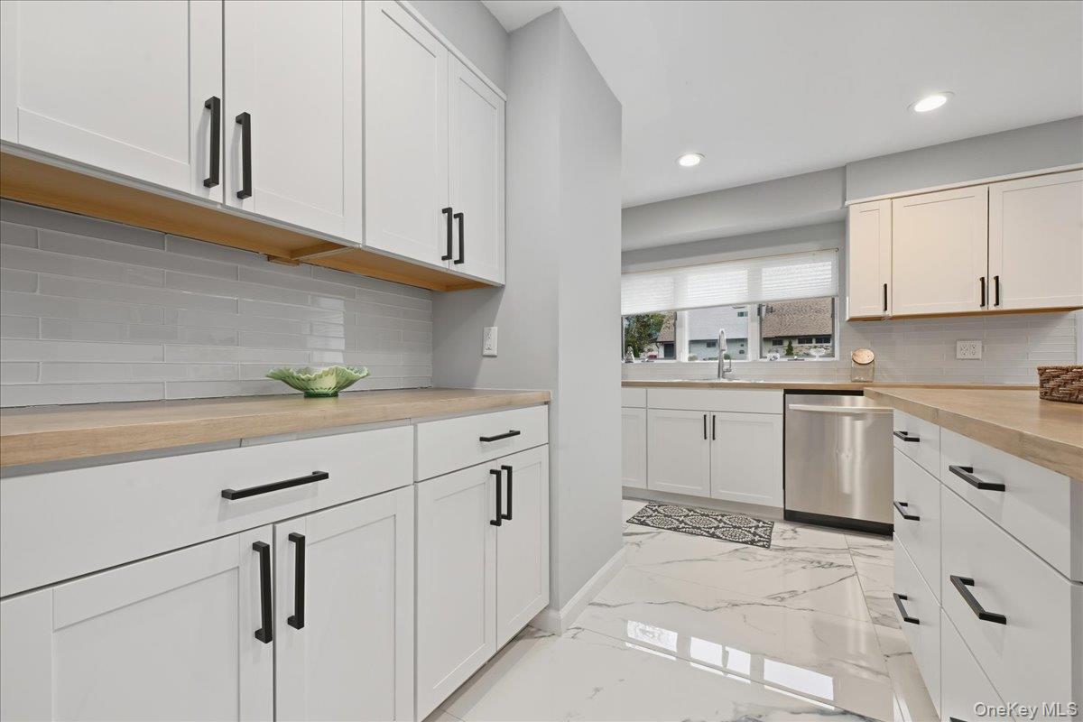 16 Ridge Drive East Roslyn, NY 11576 - Photo 8 of 40 a kitchen with cabinets appliances a sink and a counter top