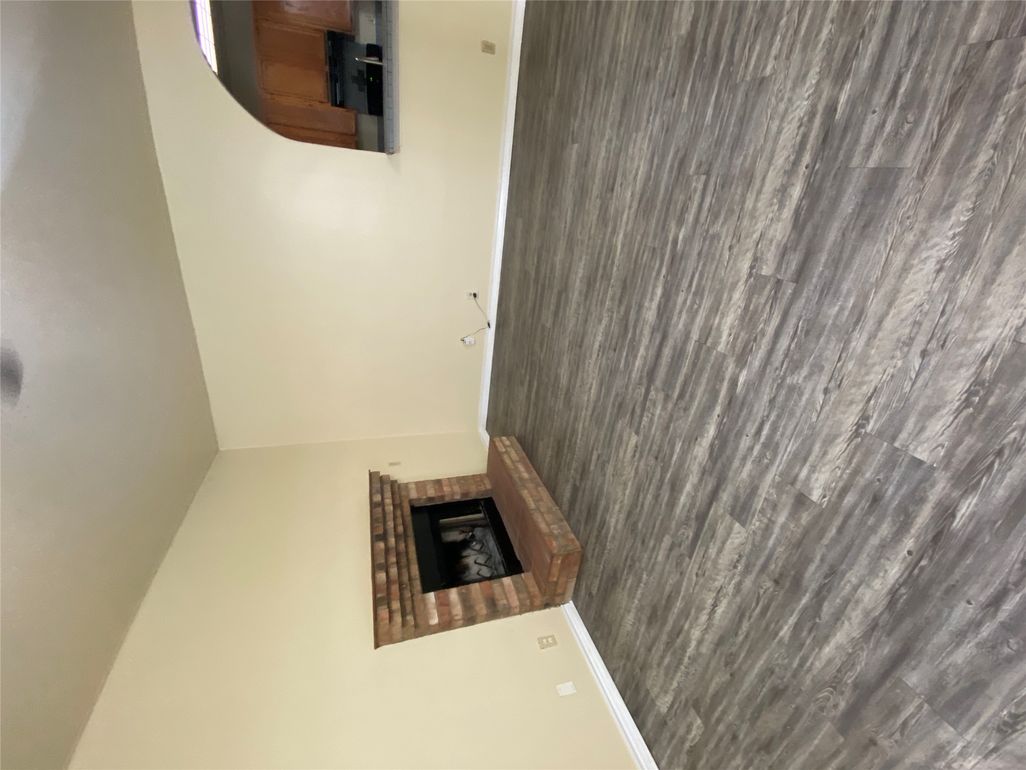 2605 Alcott Lane, Unit B Austin, TX 78748 - Photo 3 of 15 A classic brick fireplace adds warmth to this versatile living area, complemented by sleek vinyl plank flooring.