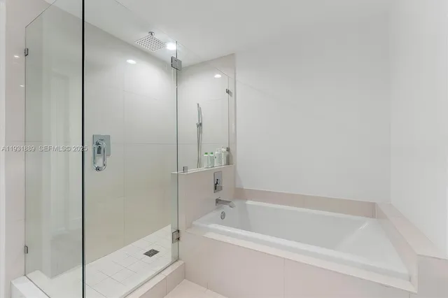 a bathroom with a bathtub and a shower