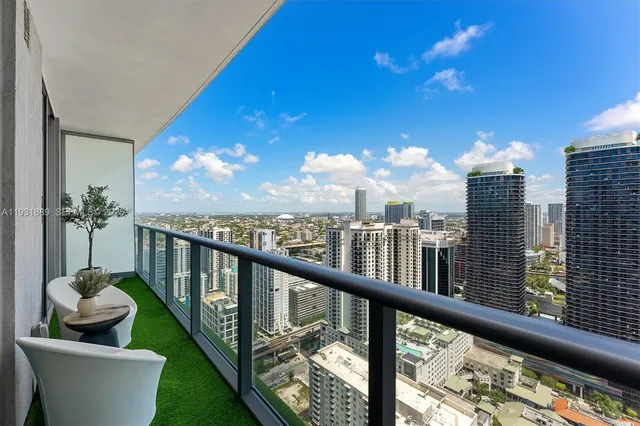 a view of a balcony with potted plants