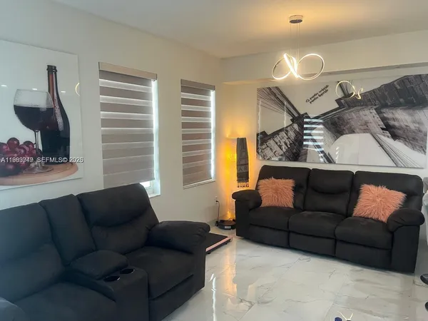a living room with furniture and a flat screen tv