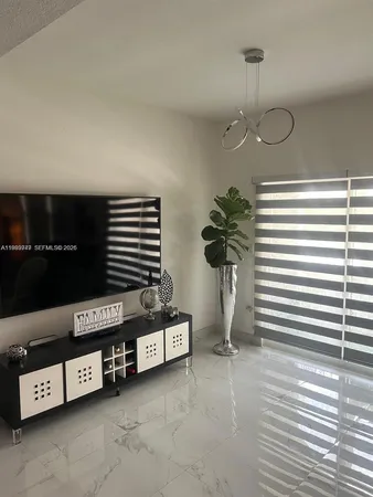 a view of a livingroom with furniture and a potted plant