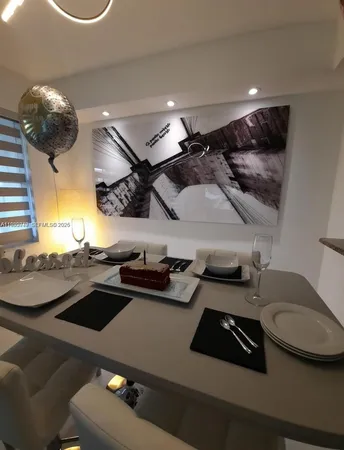 a view of a porch with furniture and floor to ceiling window