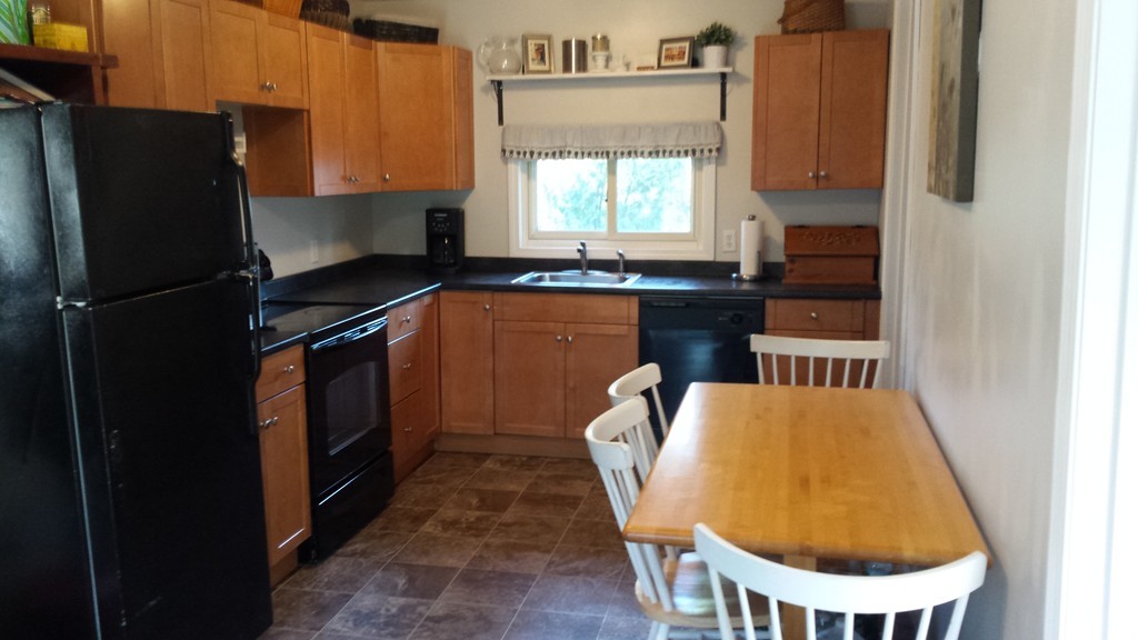68 Indian Lane Canton, MA 02021 - Photo 3 of 10 a kitchen with sink refrigerator and window