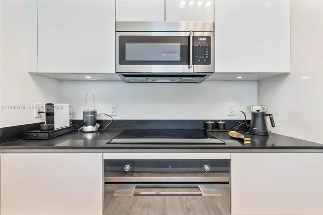 a kitchen with a stove and a microwave