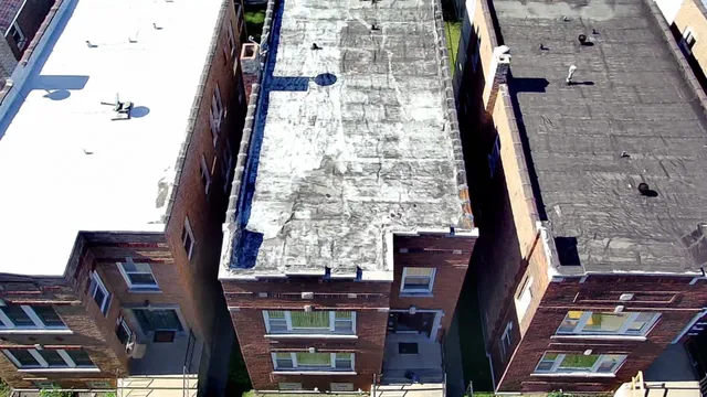 an aerial view of a residential apartment building with a yard