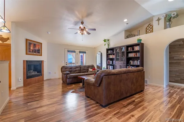 a living room with furniture and a fireplace