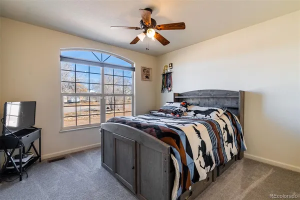 a bed sitting in a room next to a window
