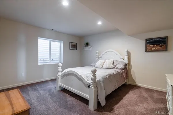 a bed sitting in a bedroom next to a window