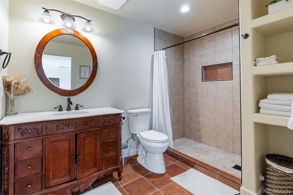 a bathroom with a toilet a sink and a mirror