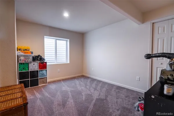 an empty room with closet and window