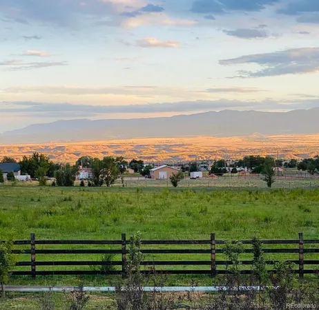 a view of a field with a mountain view in back