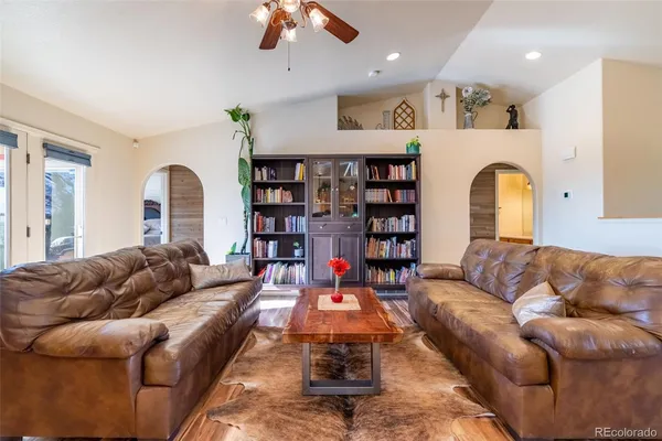 a living room with furniture a rug and white walls