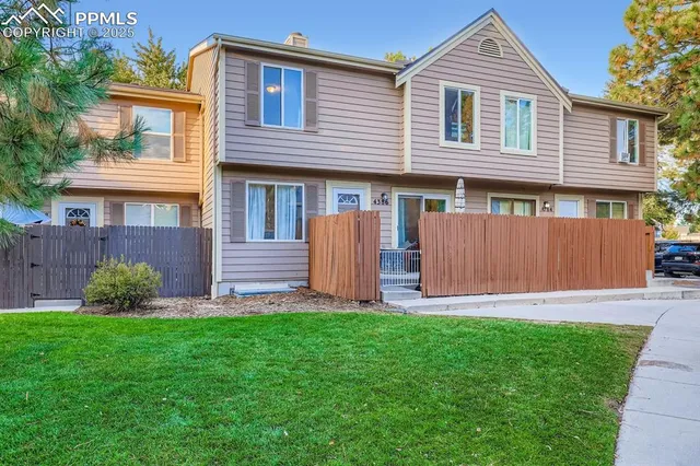 a front view of a house with a yard and a fence