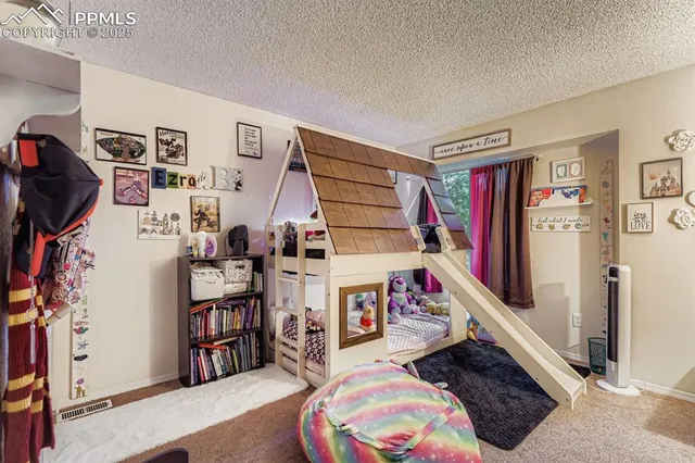 a living room with lots of furniture and a book shelf