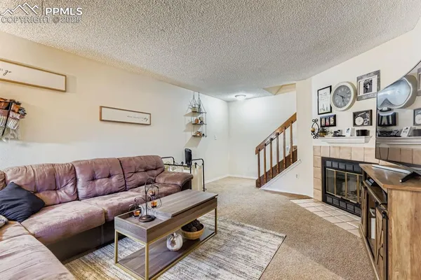 a living room with furniture and stairs