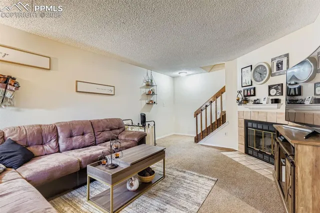 a living room with furniture and stairs