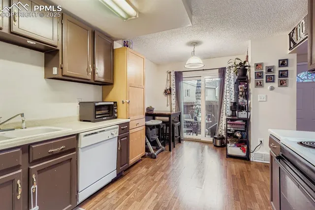 a kitchen with cabinets a sink and appliances