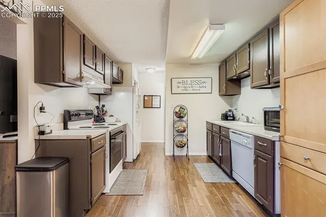 a kitchen with stainless steel appliances granite countertop a stove a sink dishwasher and a refrigerator