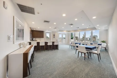 a living room with furniture a dining table and kitchen view