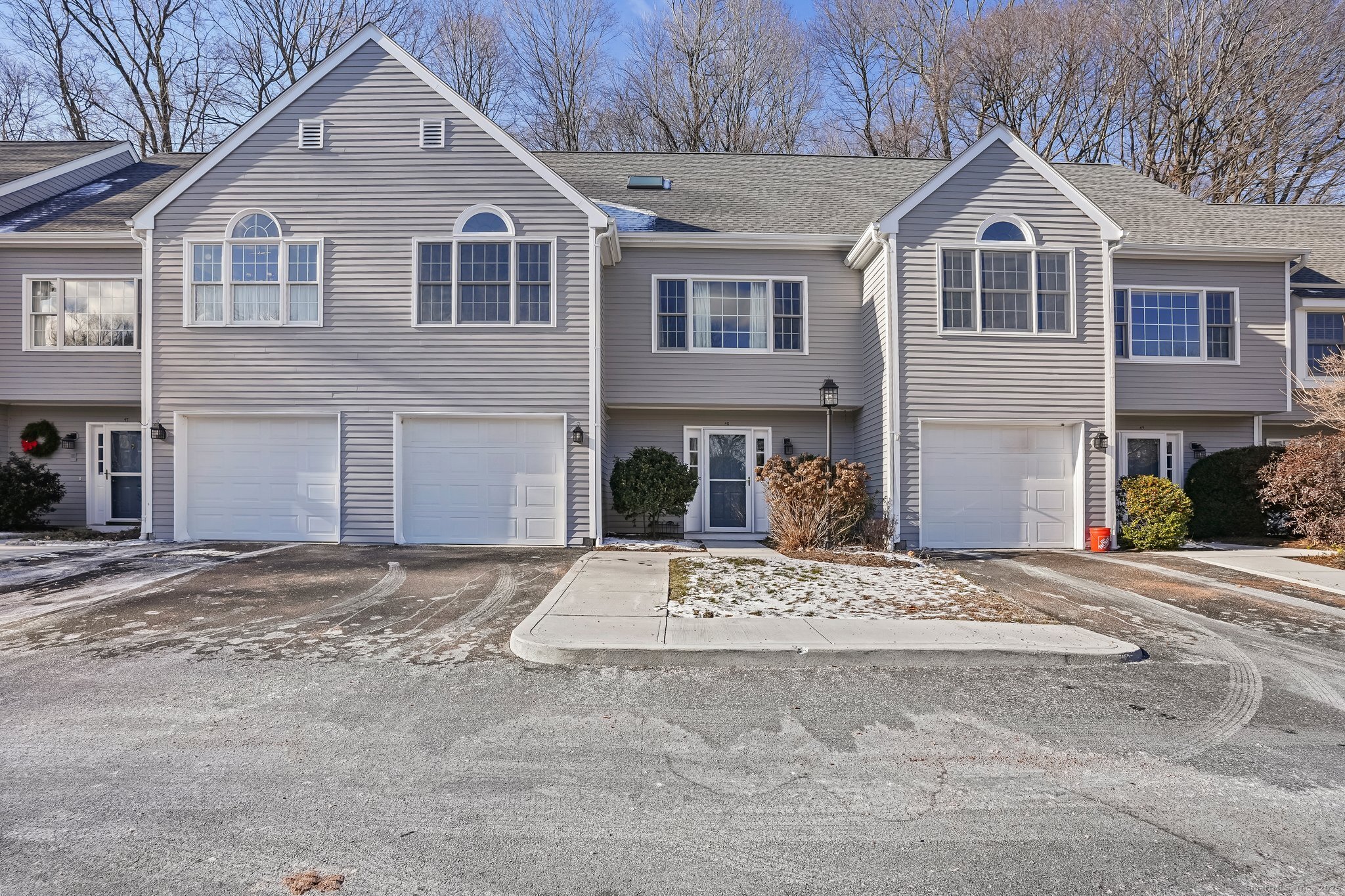 120 Prospect Street, Unit 48 Ridgefield, CT 06877 - Photo 1 of 38 a front view of a house with a yard and garage
