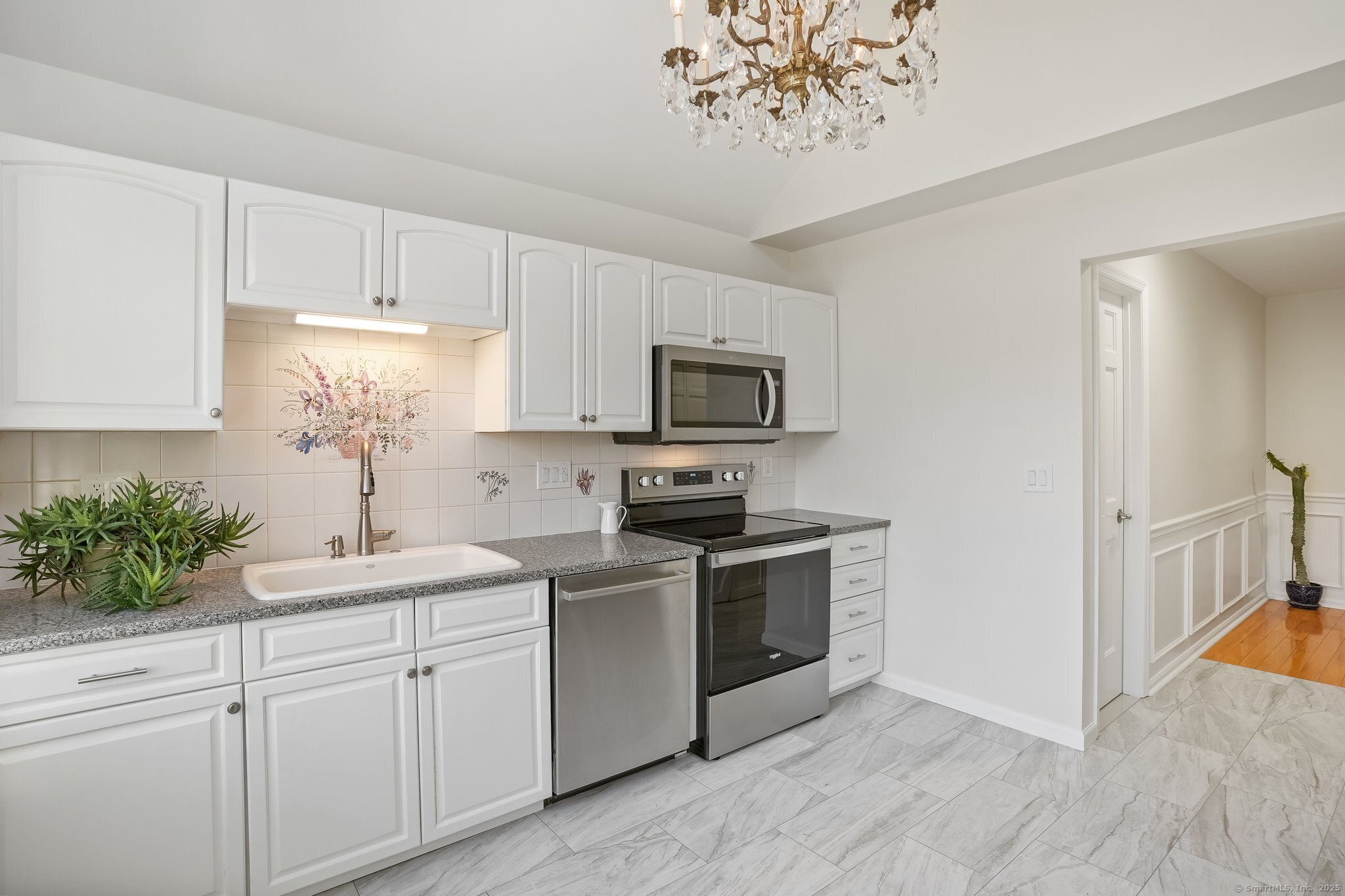 120 Prospect Street, Unit 48 Ridgefield, CT 06877 - Photo 15 of 38 a kitchen with white cabinets sink and stove