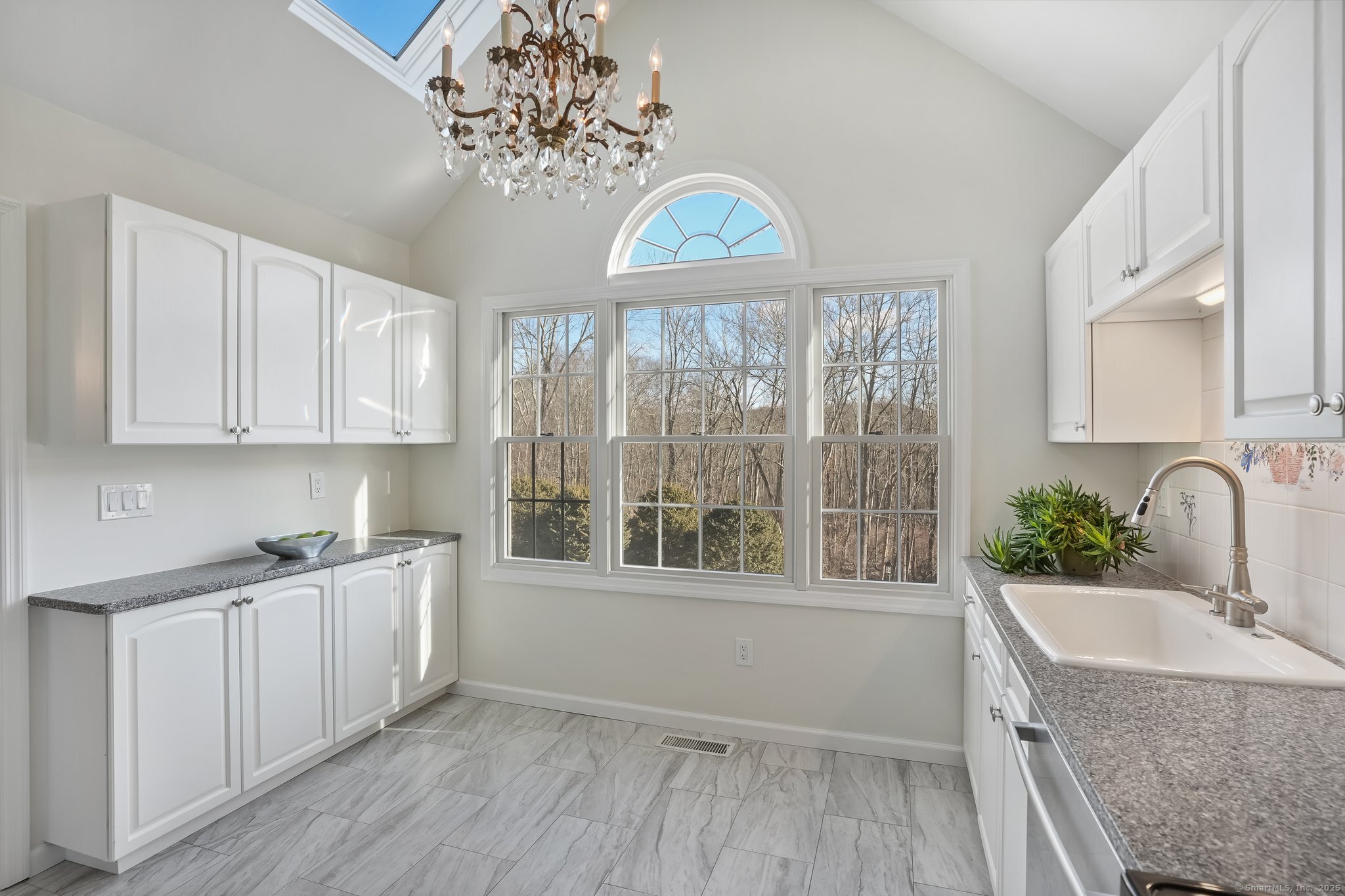 120 Prospect Street, Unit 48 Ridgefield, CT 06877 - Photo 16 of 38 a view of a kitchen with a sink dishwasher microwave oven and cabinets