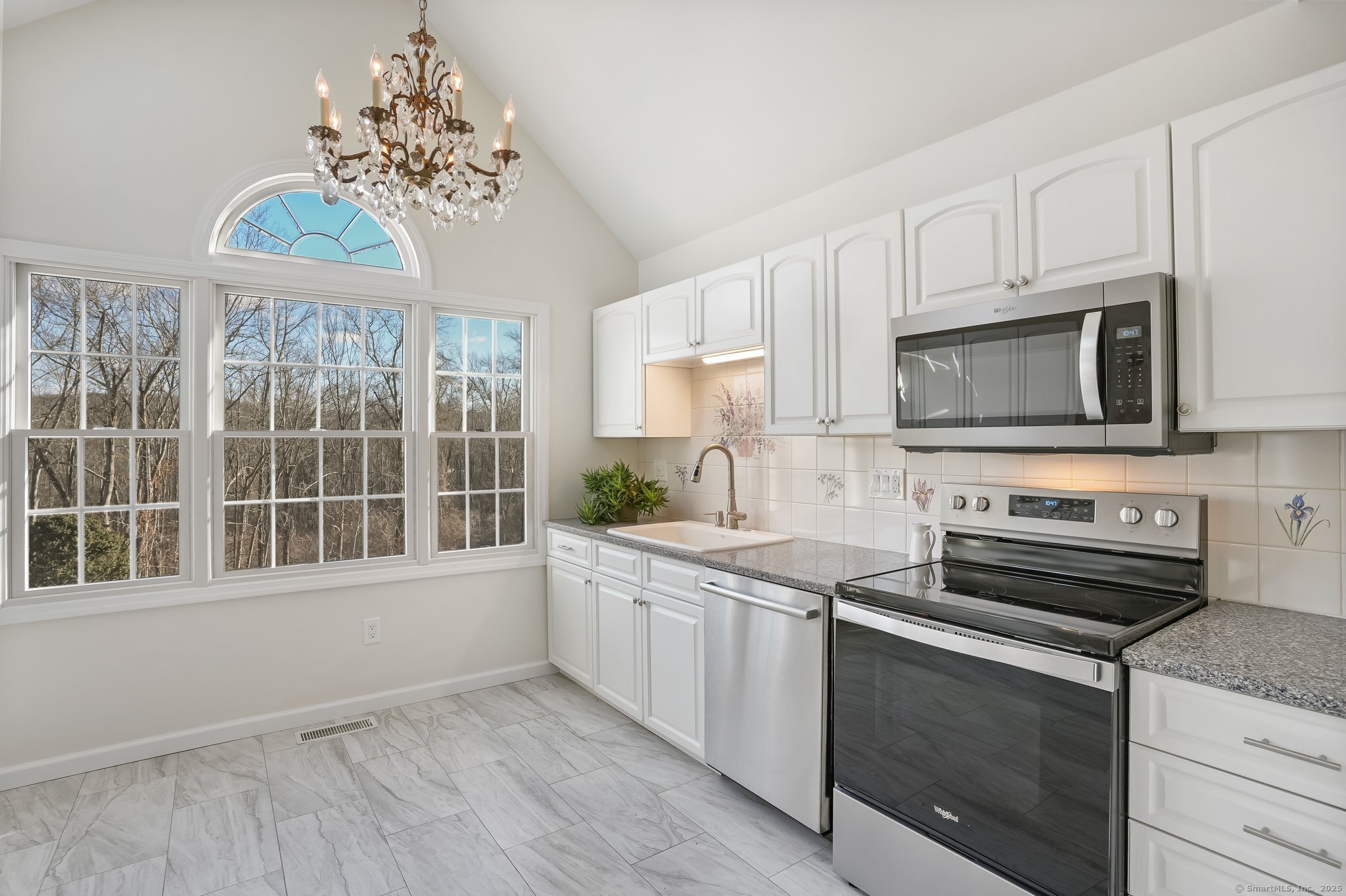 120 Prospect Street, Unit 48 Ridgefield, CT 06877 - Photo 17 of 38 a kitchen with a sink stove and microwave