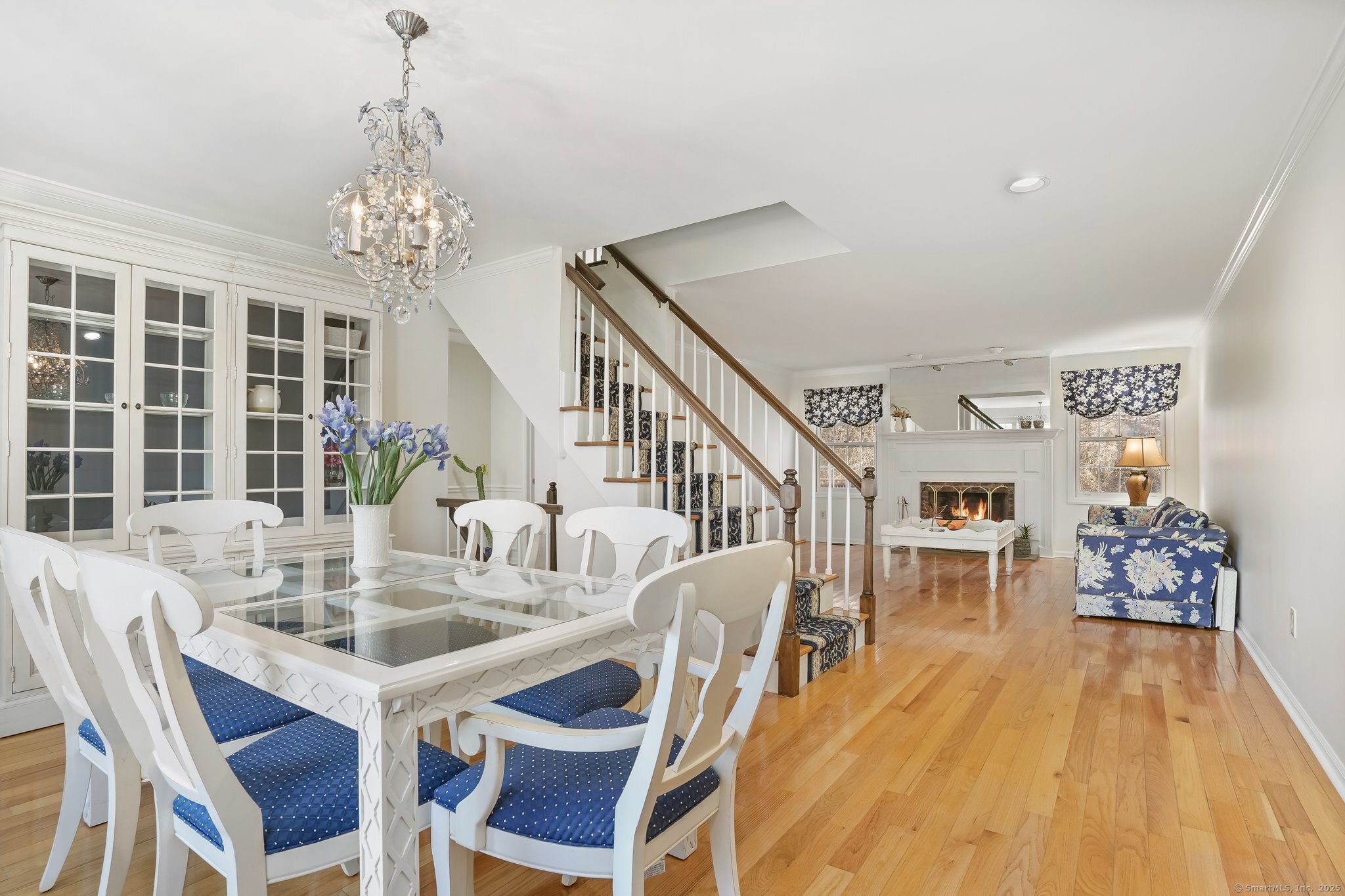 120 Prospect Street, Unit 48 Ridgefield, CT 06877 - Photo 19 of 38 a view of a dining room with furniture a chandelier and wooden floor