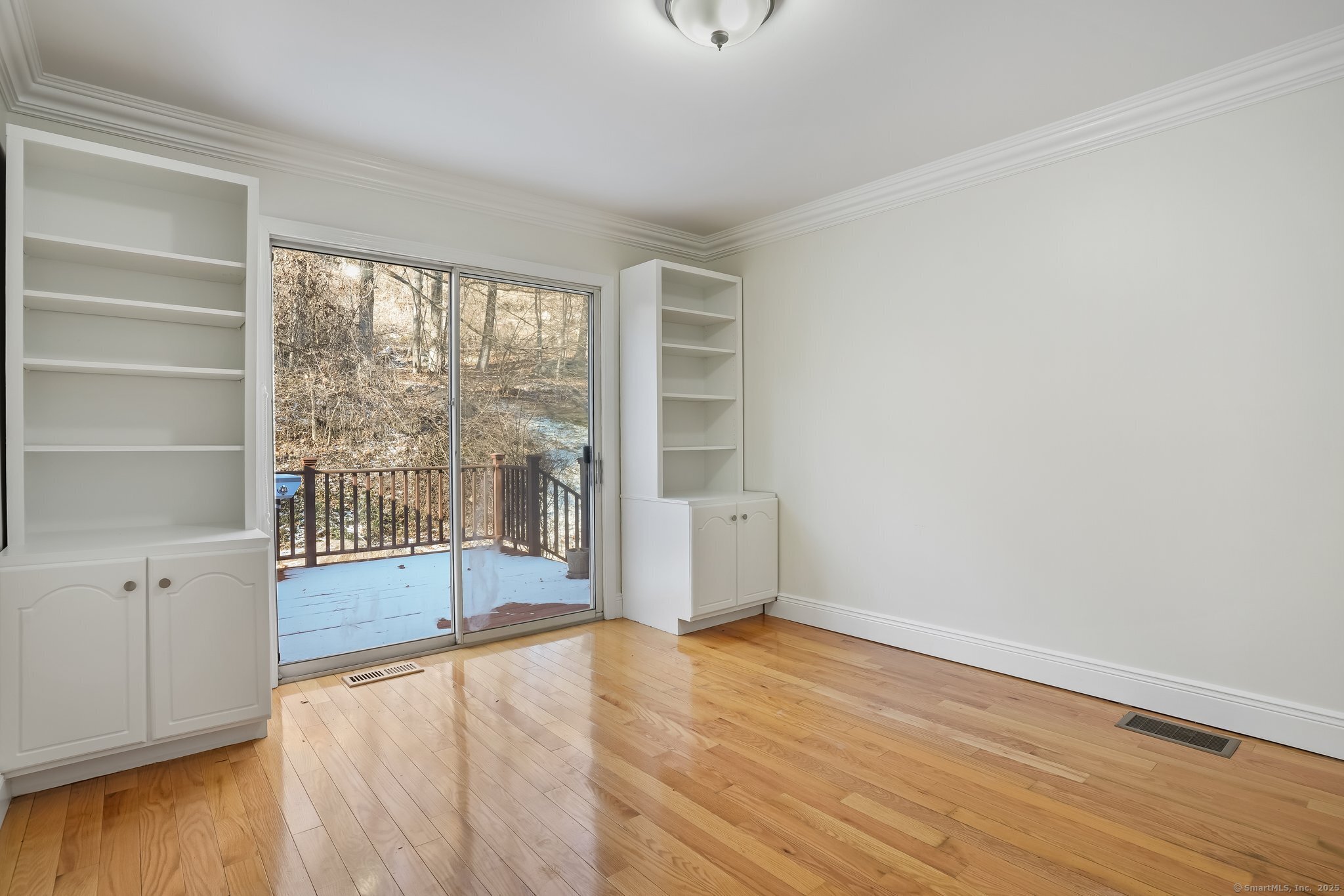 120 Prospect Street, Unit 48 Ridgefield, CT 06877 - Photo 23 of 38 an empty room with wooden floor and windows