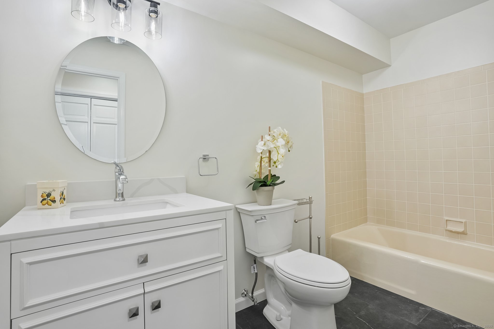 120 Prospect Street, Unit 48 Ridgefield, CT 06877 - Photo 25 of 38 a bathroom with a sink a toilet and a mirror