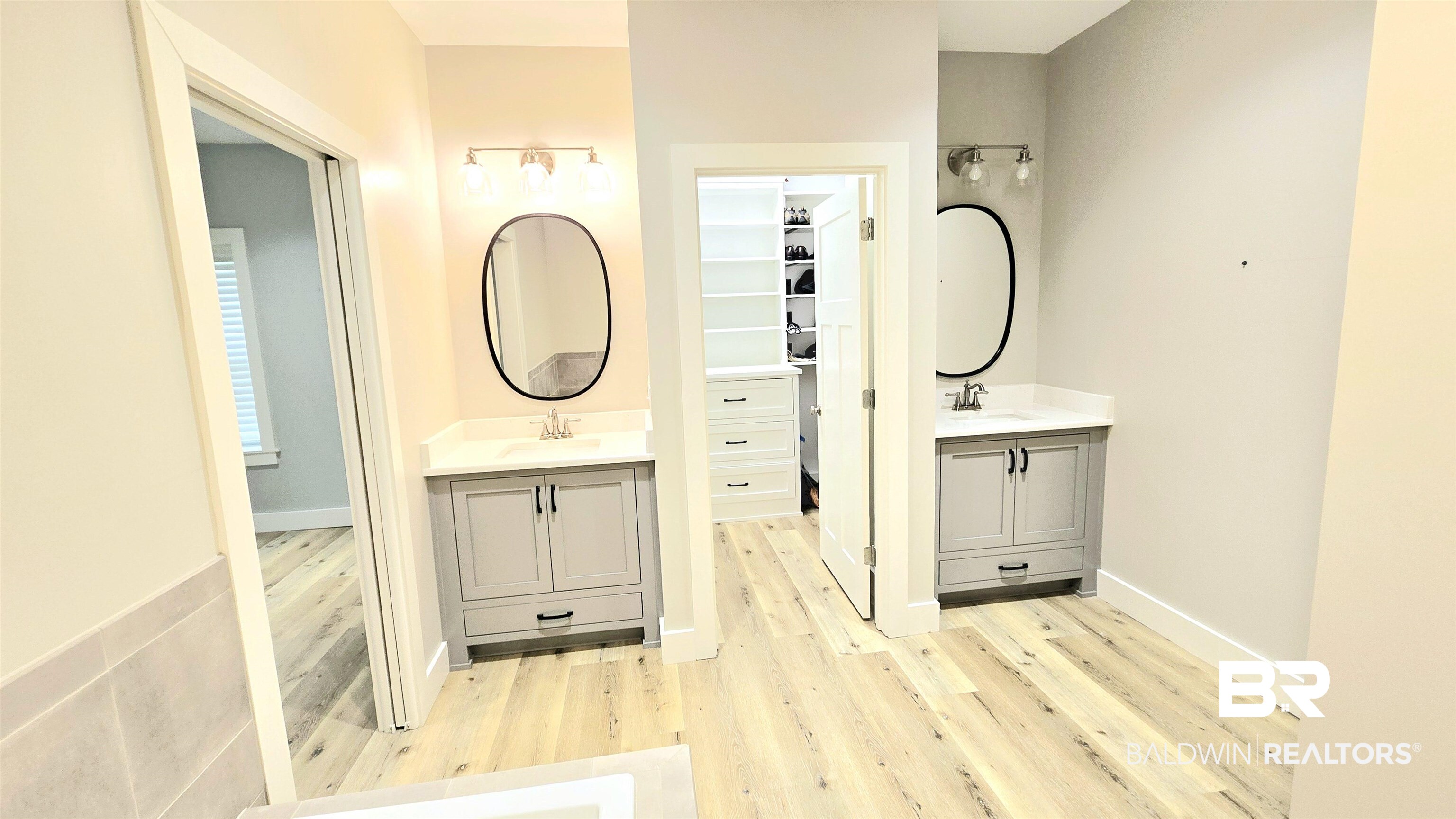 12437 Charlie Head Road Stapleton, AL 36578 - Photo 20 of 35 Full bathroom featuring wood finished floors and two vanities