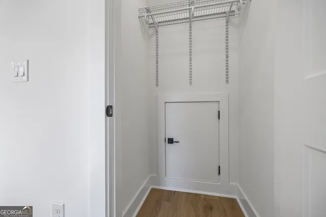 a view of a hallway with wooden floor