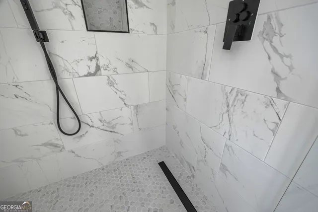 a white toilet sitting next to a bath tub