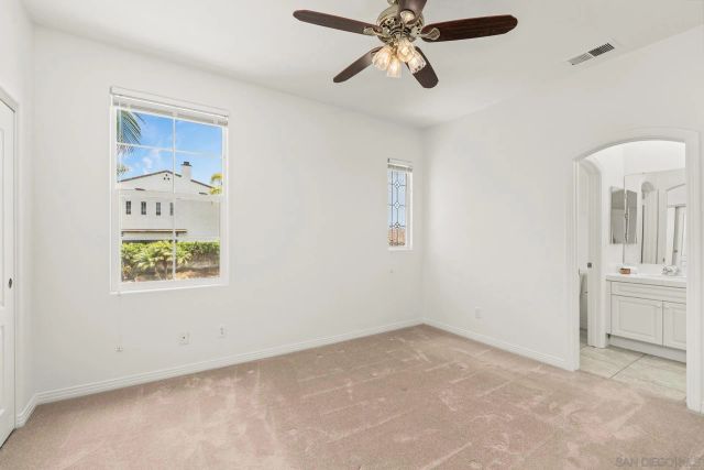 a view of a pathway of a house with wooden fence