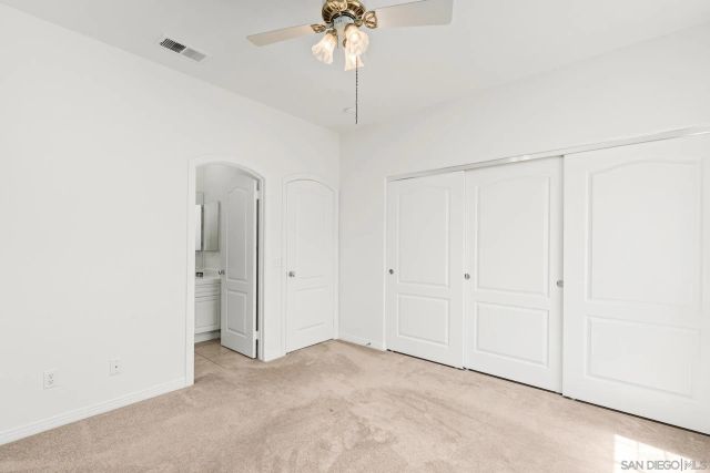 an empty room with windows and closet