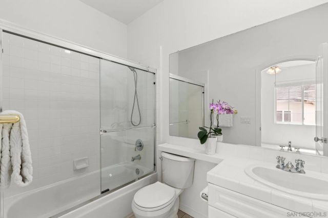 a large white kitchen with a large window
