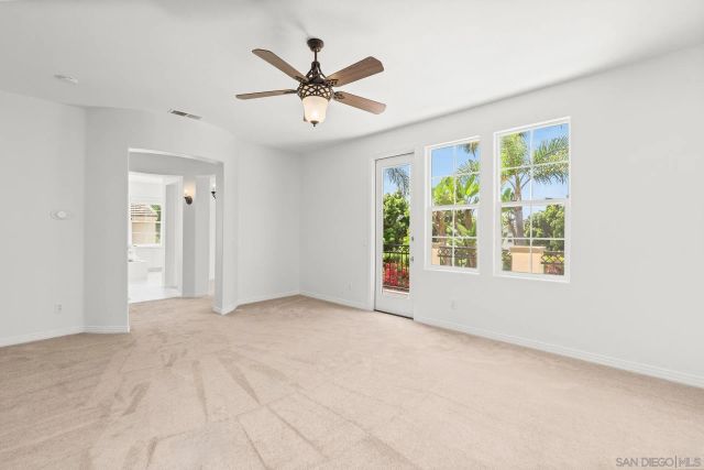 a view of a backyard with a table and chairs under an umbrella