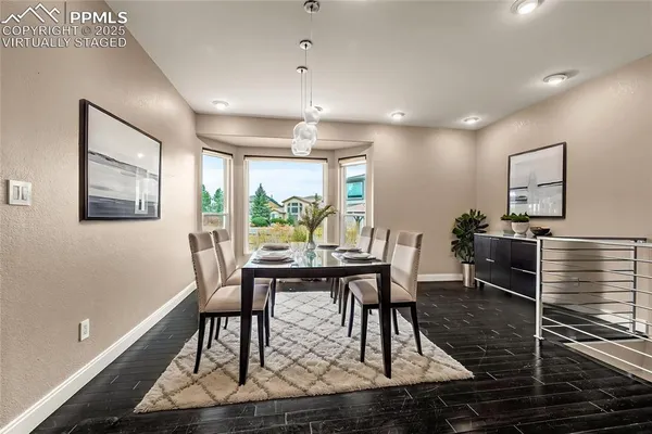 a view of a dining room with furniture window and wooden floor
