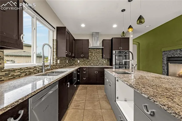 a large kitchen with stainless steel appliances granite countertop a sink and a stove