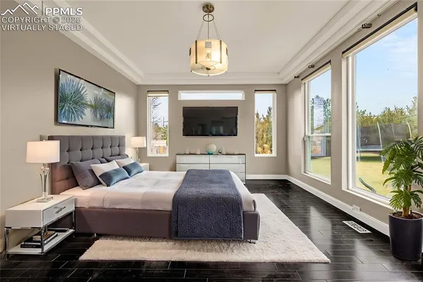 a bedroom with a large bed and a chandelier