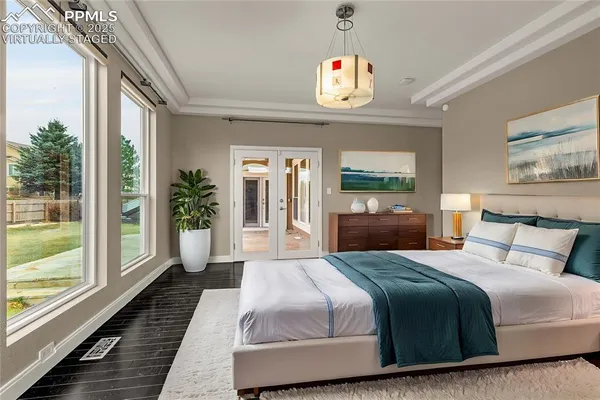 a bedroom with bed and a large window