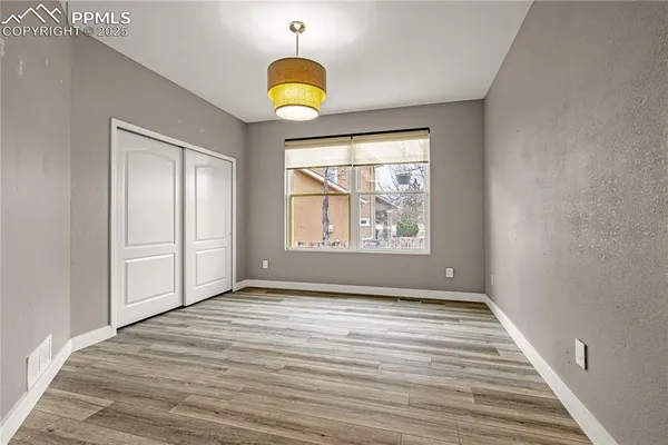 a view of a room with wooden floor and windows