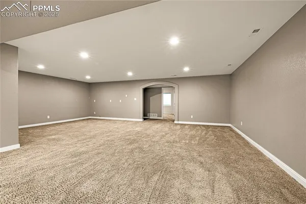 a view of an empty room with a ceiling fan