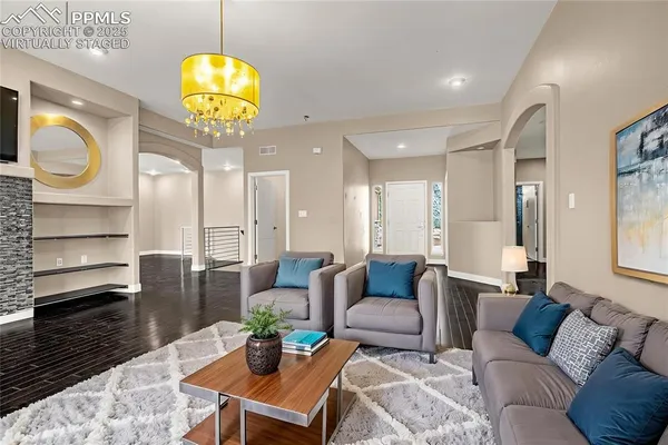 a living room with furniture and a wooden floor